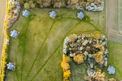 an overhead view of a field with houses and trees at Skylark - Sweffling Hall in Rendham