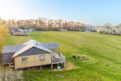 an aerial view of a house in a field at Swallow - Sweffling Hall in Rendham