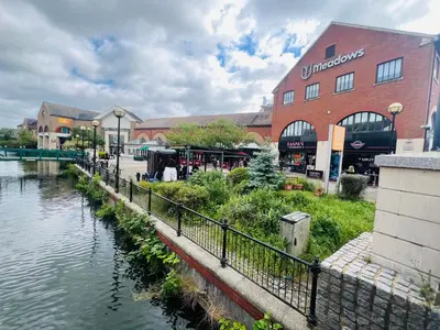 a building next to a river next to a building at Chelmsford City Centre Modern Duplex With Parking, Wi-Fi & Netflix in Chelmsford
