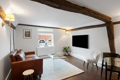a living room with a couch and a tv at Beautiful period property in historic town in Braintree