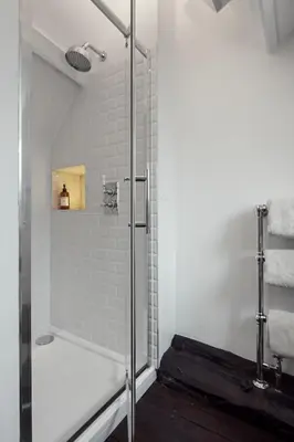 a shower with a glass door in a bathroom at Beautiful period property in historic town in Braintree