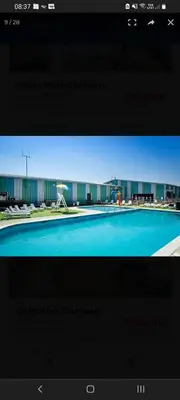 a television screen with a picture of a swimming pool at SKYLA VISTA Deluxe in Clacton-on-Sea