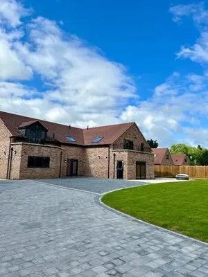 a large brick building with a driveway at Cosy nook in Hardwick