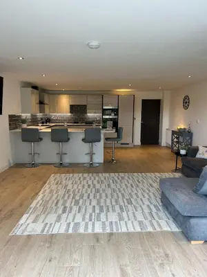 a living room with a couch and a kitchen at Cosy nook in Hardwick