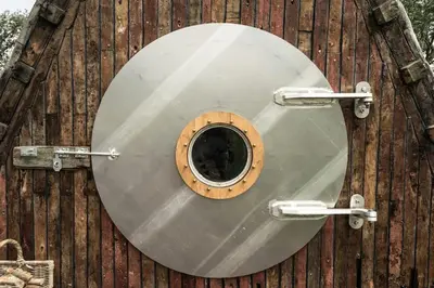 a metal toilet seat on a wooden structure at Unique glamping experience near Ely & Cambridge in Ely
