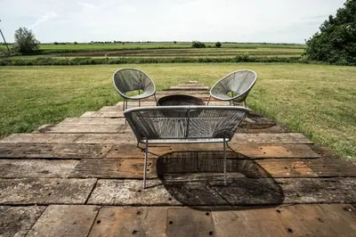 two chairs sitting on top of a wooden floor at Unique glamping experience near Ely & Cambridge in Ely