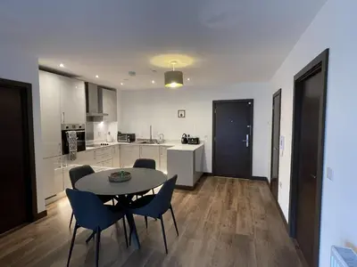 a kitchen and dining room with a table and chairs at The Melodies with Free Parking , Harlow in Harlow