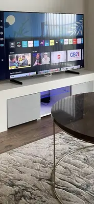 a living room with a tv and a table at The Melodies with Free Parking , Harlow in Harlow