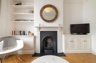 a living room with a fireplace and a mirror at Charming Kings road in Bury Saint Edmunds