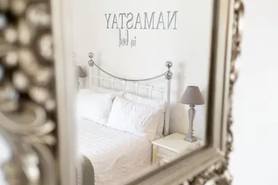 a mirror reflection of a bed in a bedroom at Charming Kings road in Bury Saint Edmunds