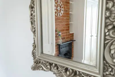 a mirror reflection of a fireplace in a room at Charming Kings road in Bury Saint Edmunds