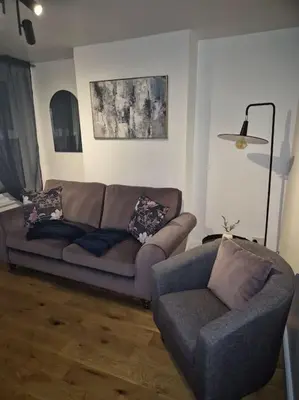a living room with a couch and a chair at Sizewell - Contractors - Free Parking - Vacation in Leiston