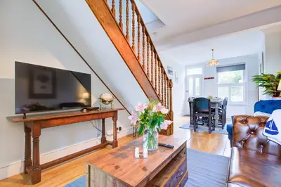 a living room with a tv and a couch at Stunning Cottage in the Heart of Old Leigh - Pass the Keys in Southend-on-Sea