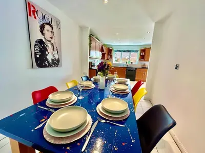 a blue table with chairs and plates on it at 6 Bedroom House - DISC0UNTS - Parking, Contractors, Group, Family in Braintree