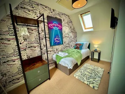 a bedroom with a bed and a wall with writing on it at 6 Bedroom House - DISC0UNTS - Parking, Contractors, Group, Family in Braintree