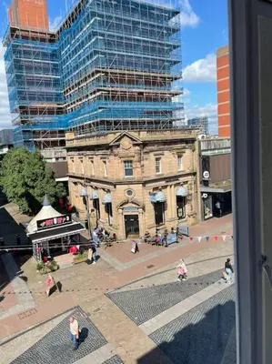 an old building in front of a tall building at Nero view, Southend City High Street in Southend-on-Sea