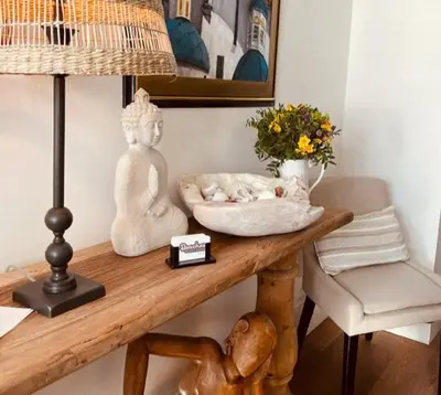 a table with a cat sleeping on top of it at Beaches Guest House in Southend-on-Sea