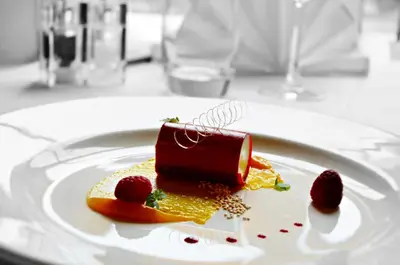 a dessert on a white plate on a table at Heritage Grange at Thurston, Hotel in Bury Saint Edmunds