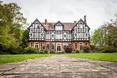 an old house with a stone driveway in front of it at Heritage Grange at Thurston, Hotel in Bury Saint Edmunds