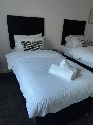 a bedroom with two beds with towels on them at 3 Bed Barn in Cambridge next to Anglesey Abbey in Cambridge