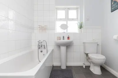 a white bathroom with a toilet and a sink at Entire House - Contractor's, Families & More in Little Wymondley