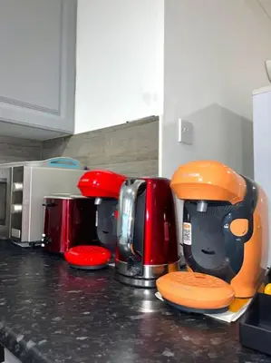 a kitchen counter with a row of coffeemakers at 12 Penn Gardens Standard Room- 4 in Friern Barnet