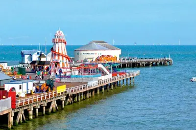 a pier with a amusement park on the water at Clacton Guest House in Clacton-on-Sea