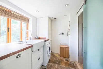 a kitchen with a sink and a washing machine at Little Swattesfield, Eye in Eye