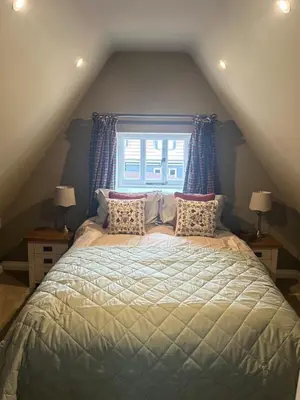 a bedroom with a large bed with a window at Trowel and Hammer Flat 1 in Cotton