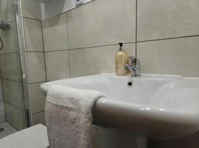a bathroom with a sink with a soap dispenser on it at Contractors l FreeParking l Station l Students in Colchester