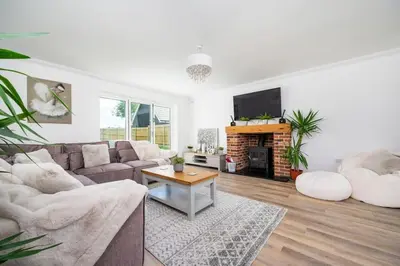 a living room with a couch and a tv at Kestral House in Eye