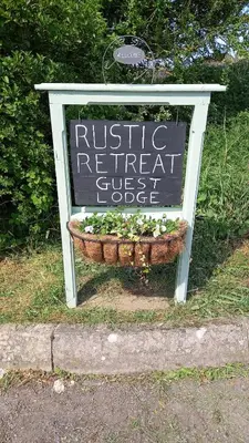 a sign for a rustic retreat guest object at Rustic Retreat Guest Lodge in Littleport