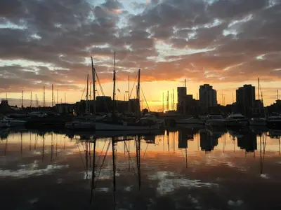a group of boats docked in a harbor at sunset at Modern Ipswich Waterfront Apartment Free Parking - Long Term Stays Available in Ipswich