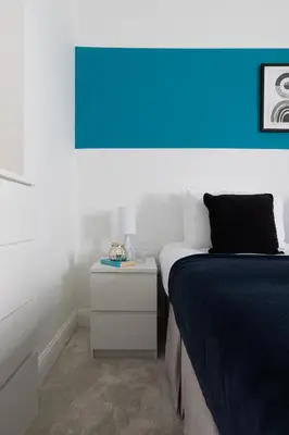 a bedroom with a bed and a blue light at Stunning Spacious 4 Bed bungalow in Southend-on-Sea