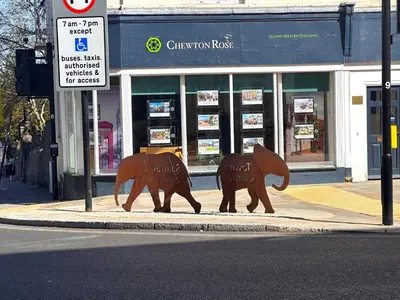 a statue of two elephants walking down a street at Colchester City Luxury With Free Parking and 5 G WIFI in Colchester