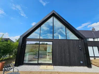 a black house with large glass windows at Field View in Elmswell