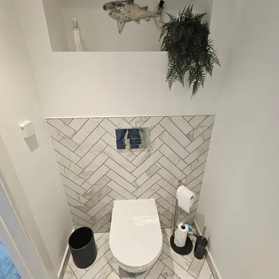 a bathroom with a white toilet in a room at Field View in Elmswell