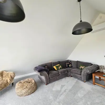 a living room with a couch and a chair at Field View in Elmswell