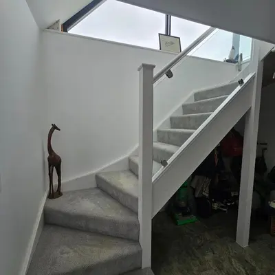 a staircase in a house with a giraffe statue at Field View in Elmswell