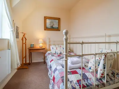 a bedroom with a bed with a quilt on it at 1 Market Hill in Woodbridge