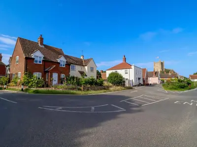 an empty street with houses in a town at 1 Market Hill in Woodbridge
