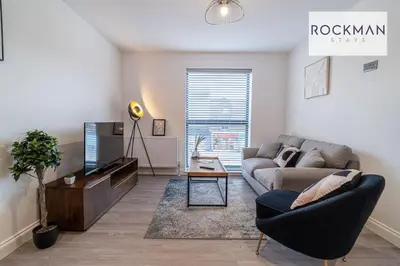 a living room with a couch and a tv at Royal Oak Apartments 9 - Free Secure Parking - 2 Bedrooms - Perfect for Contractors in Brentwood