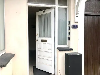 a white door on a house with a window at Ac Lounge 36 Room A in Rochford