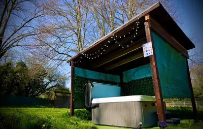 a building with a bench in the grass at Rocklands Retreat in Rockland Saint Peter