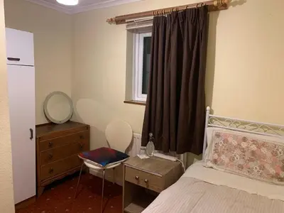 a bedroom with a bed and a mirror and a dresser at Lawrence House in Cambridge