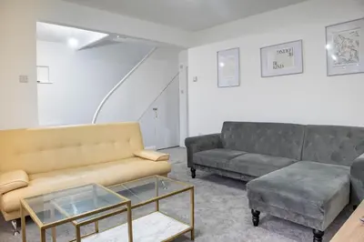 a living room with two couches and a coffee table at Southend Retreat KING SUITE Luxury stay with parking in Southend-on-Sea