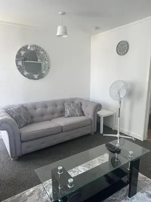 a living room with a couch and a table at Cosy 1 Bedroom Bungalow Between Basildon & Wickford in Nevendon