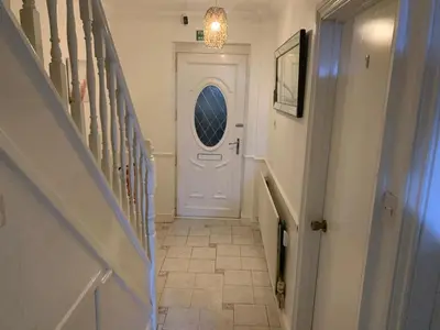 a hallway with a white door with a window at At Apex House in Horndon on the Hill
