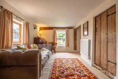 a living room with a couch and a rug at Cutbush Farm House 6 in Hingham