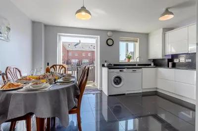 a kitchen and dining room with a table and chairs at 3 Bed in Felixstowe oc-p29748 in Felixstowe